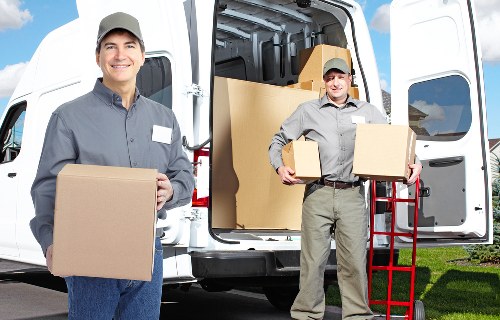 Team using safe manual handling to lift and secure household items