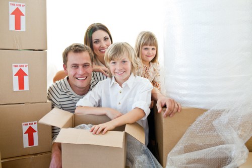 Professional movers navigating a Chiswick property with narrow access