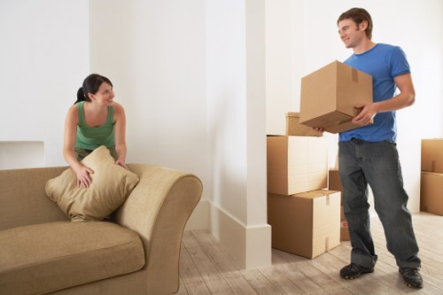 Packed moving boxes and furniture ready for transport in Chiswick